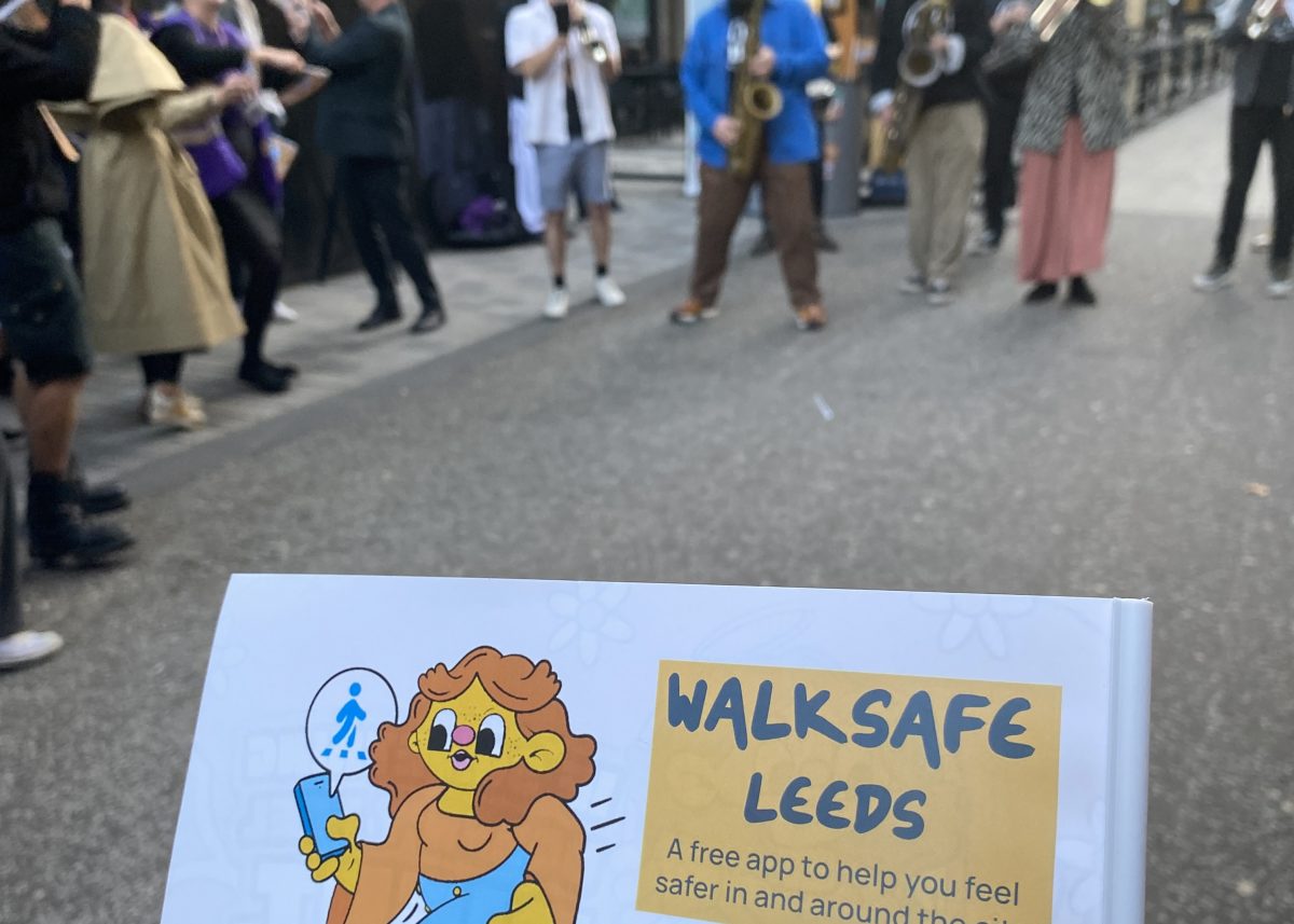 Walksafe sign in front of the brass band performing at the parade to celebrate te launch