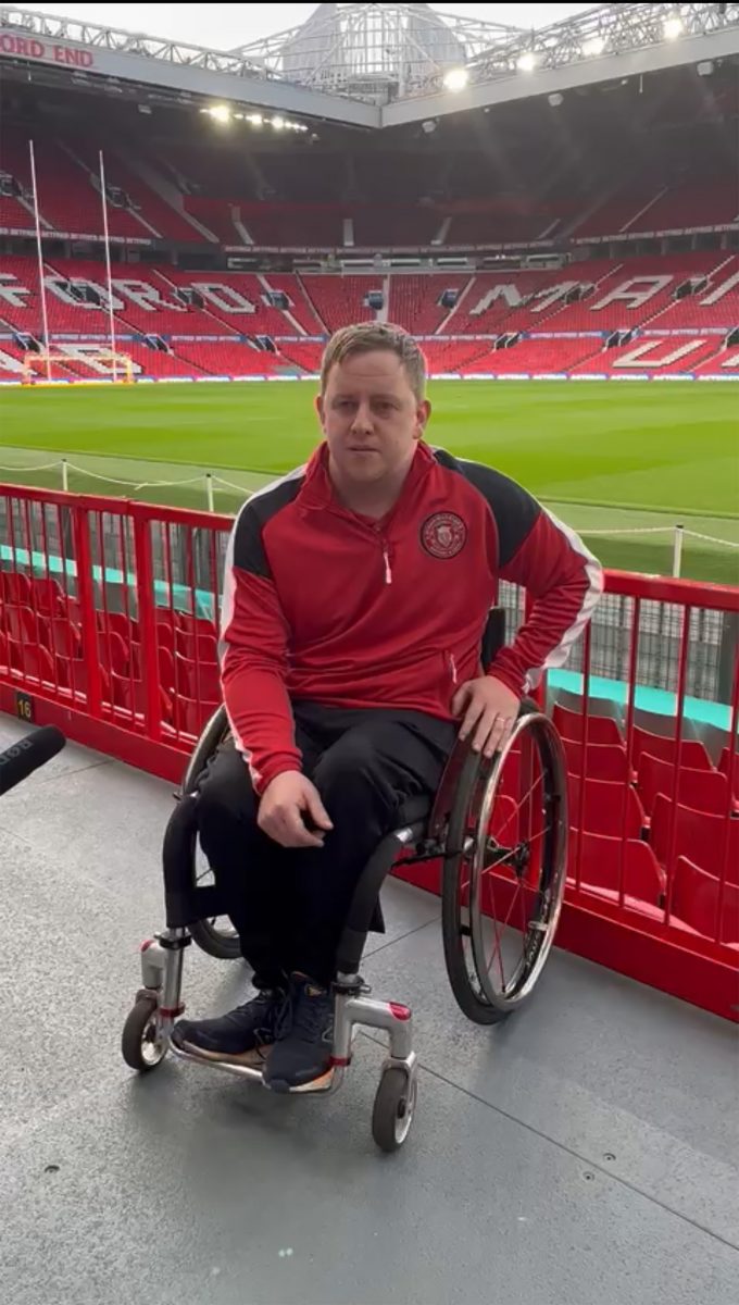 Wheelchair player Adam Rigby answering a question