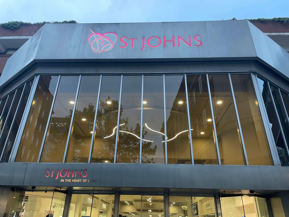 The front entrance of a shopping centre with large glass windows