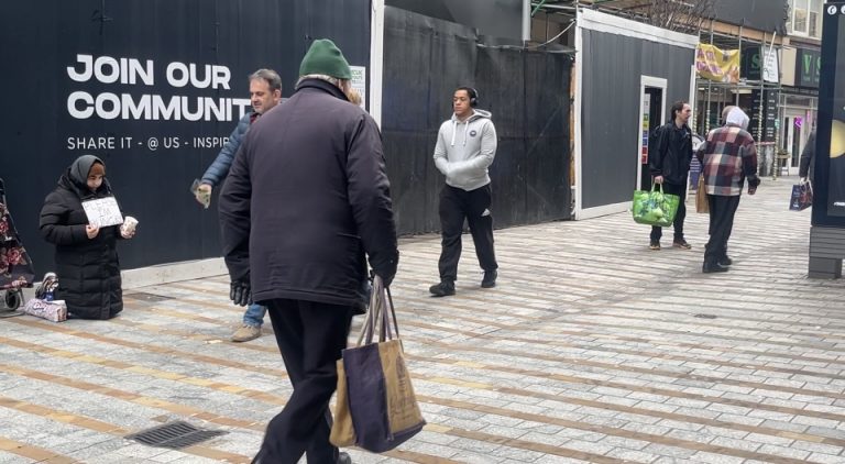Homeless woman begging on Leeds street