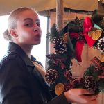 A girl holding a wreath