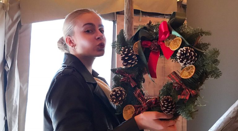 A girl holding a wreath