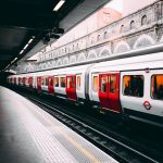white and red train beside building at daytime