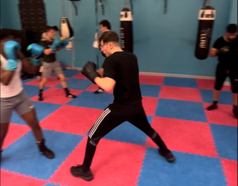 Boxers doing some movement and light jabs in pairs in a session