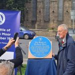 MP and Secretary of state for Northern Ireland poses with the new blue plaque