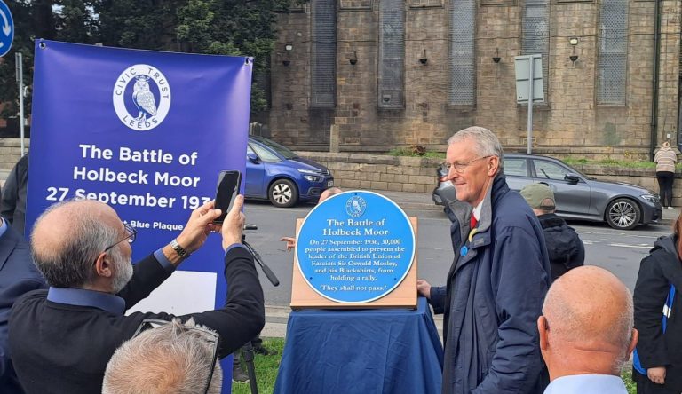 MP and Secretary of state for Northern Ireland poses with the new blue plaque