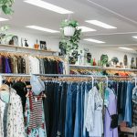assorted-color clothes hanged inside department store with lights turned on