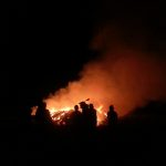 silhouette of people facing fire