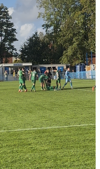 Farsley celebrate equalizer but goalscorer Conor Bransen is injured in the process