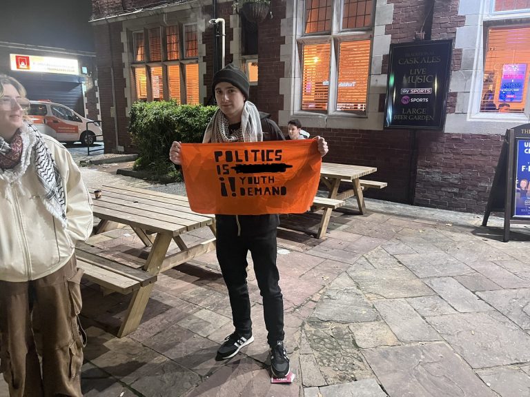 Picture of Youth Demand member holding sign