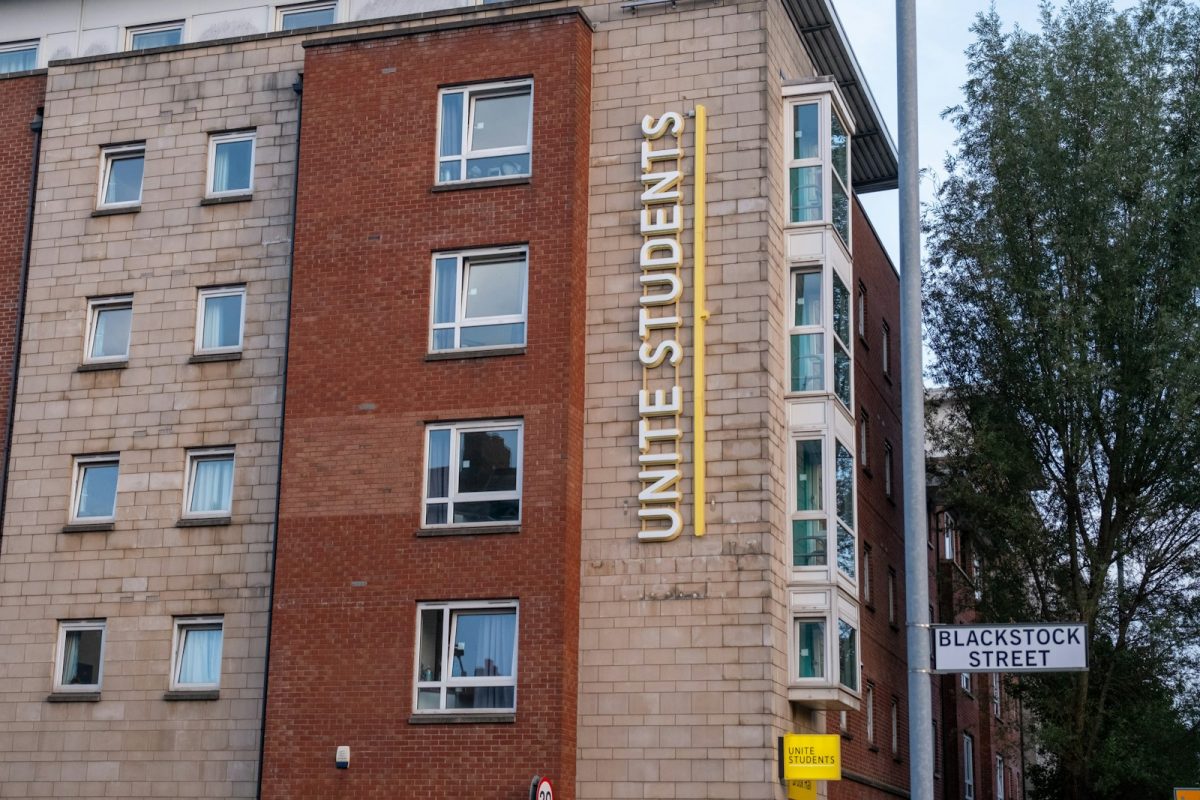 a tall brick building with a sign on the side of it