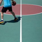 man dribbling ball on court