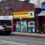 Yellow storefront of OWLS charity