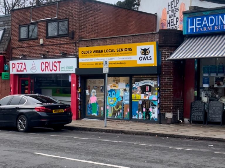 Yellow storefront of OWLS charity