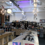 Record Plant in Farsley shows off its new home. A big room with tall ceilings and walls all painted white and adorned with hanging lights.