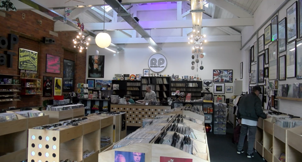 Record Plant in Farsley shows off its new home. A big room with tall ceilings and walls all painted white and adorned with hanging lights.