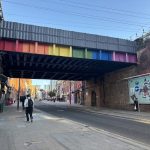 A quiet look to Lower Briggate, the rainbow railway bridge over the street home to Under the Arches