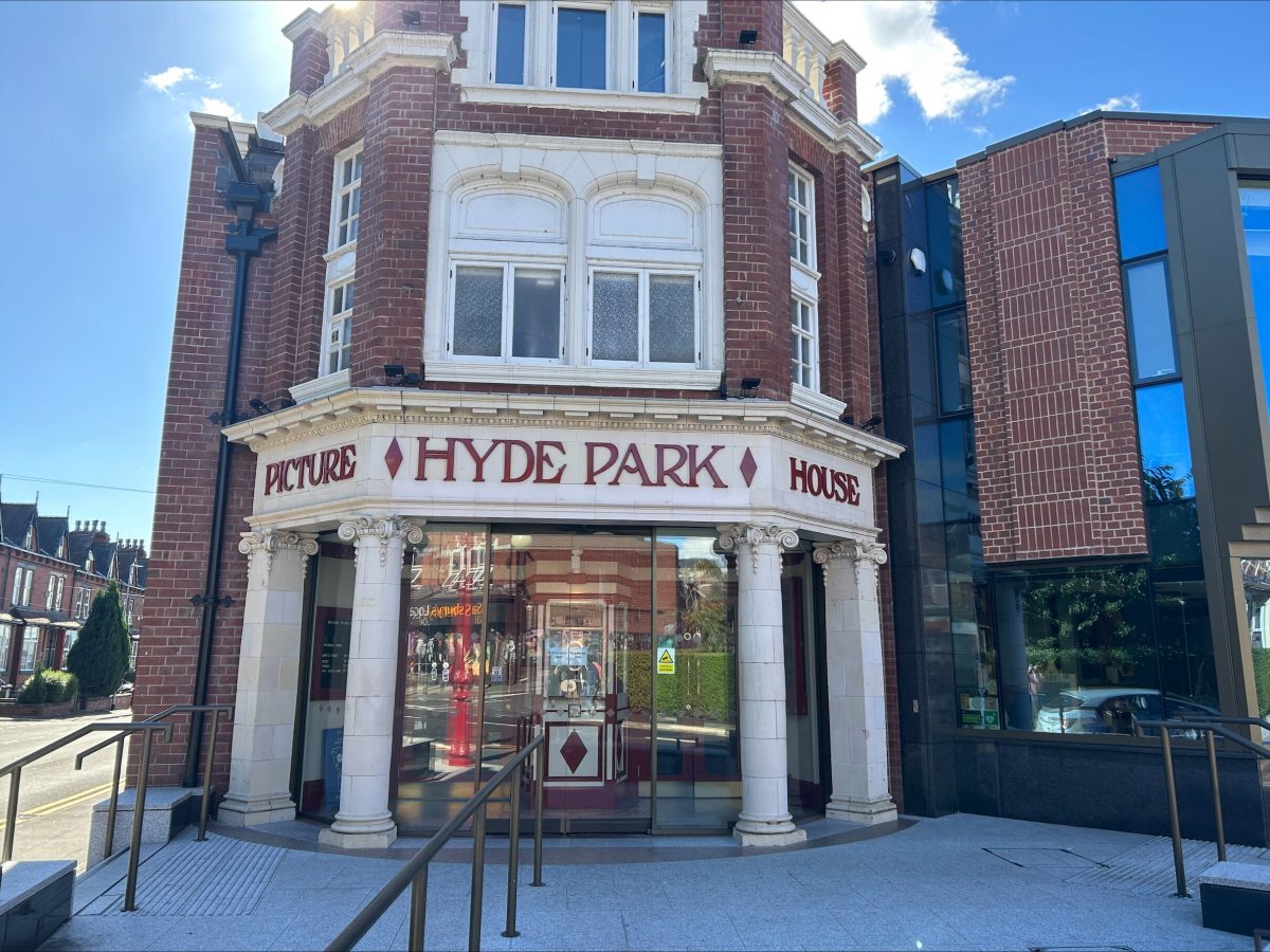 An image of a red brick building with with white stone columns and a curved glass entrance with "Hyde Park Picture House" written above in red lettering.