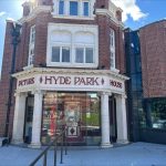 An image of a red brick building with with white stone columns and a curved glass entrance with "Hyde Park Picture House" written above in red lettering.