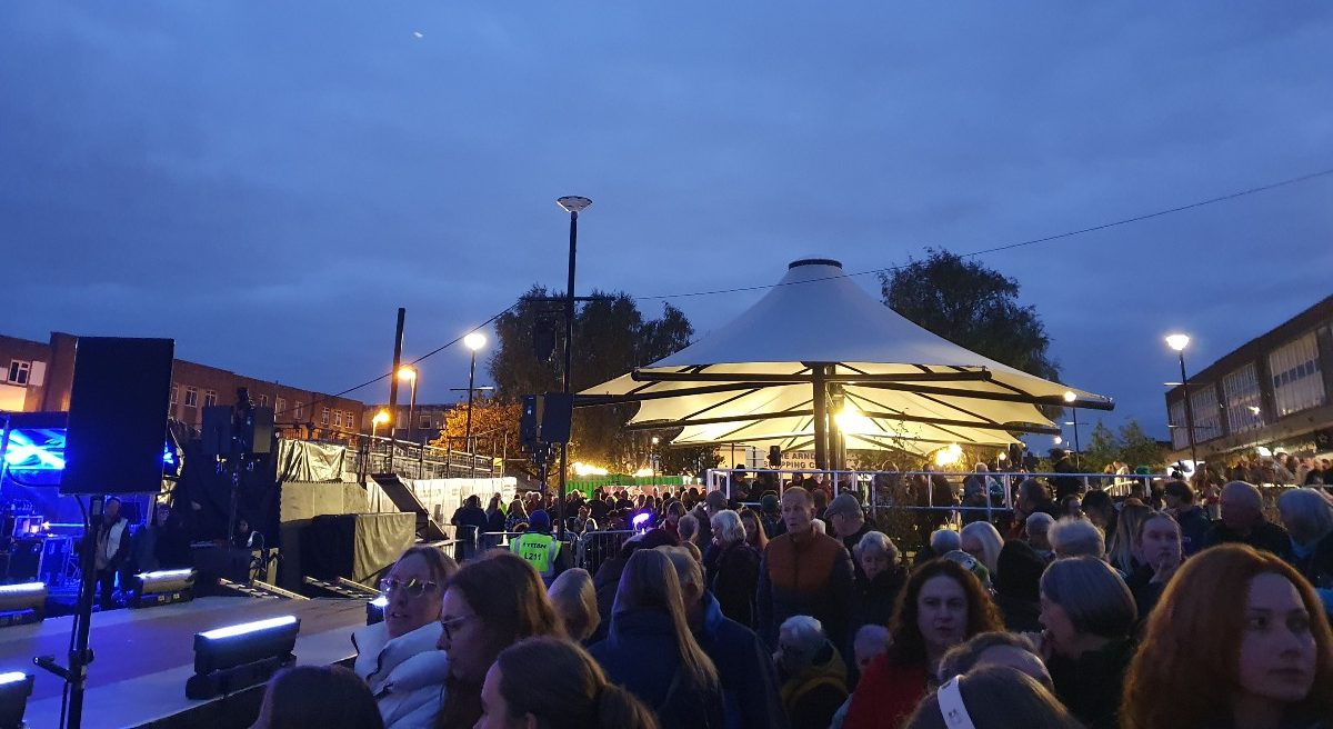 The image shows a crowd of people for the Bloom event in Shipley with the new Canopies in the background