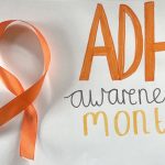 Orange ADHD awareness ribbon on the left; bold orange "ADHD" text with "awareness month" written below on the right.