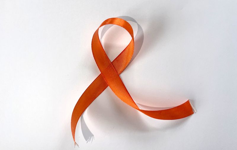 Leeds shines a light on ADHD Awareness Month 4 Orange awareness ribbon looped into an "A" shape with a shadow on a white background.