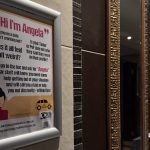 Photo of an ask for Angela sign in a women bathroom