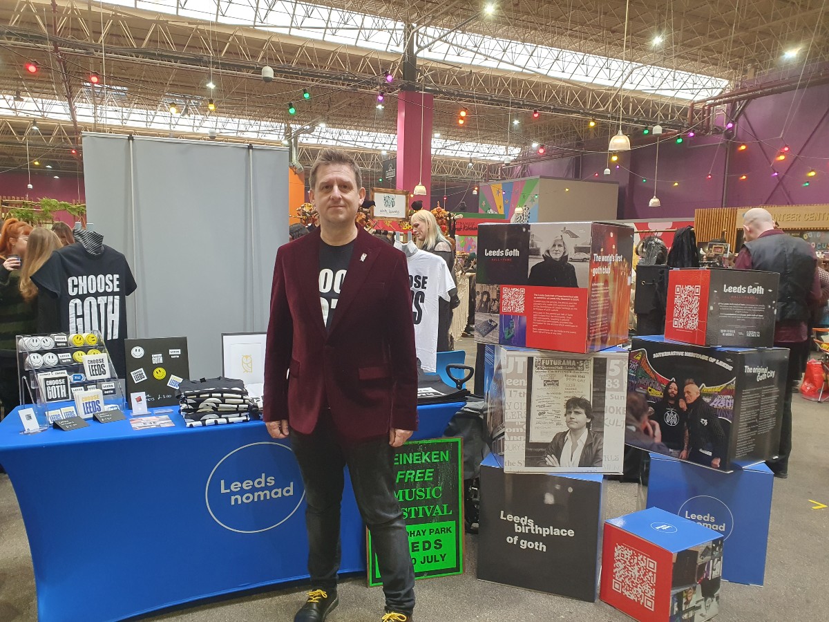 The image shows Mark Silver from the festival of gothica in front of his stall