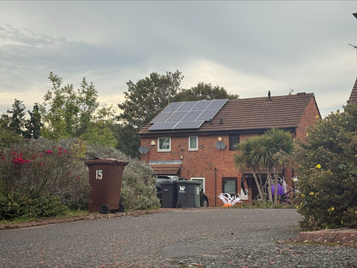 house with solar panels from view of driveway