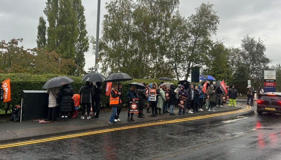 The image shows the GMB union picket line in the rain outside Airedale Hospital
