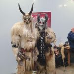 The image shows two goth festival attendees dressed in scary costumes