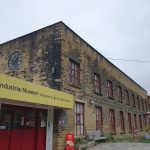 The image shows The Leeds Industrial Museum on a cloudy day in Armley