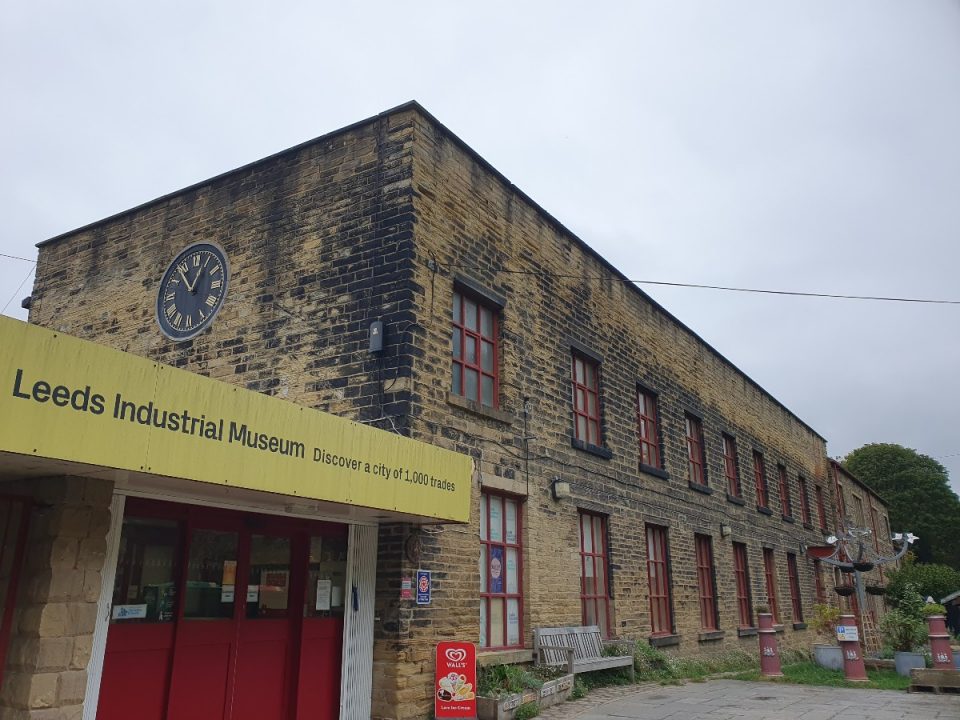 The image shows The Leeds Industrial Museum on a cloudy day in Armley
