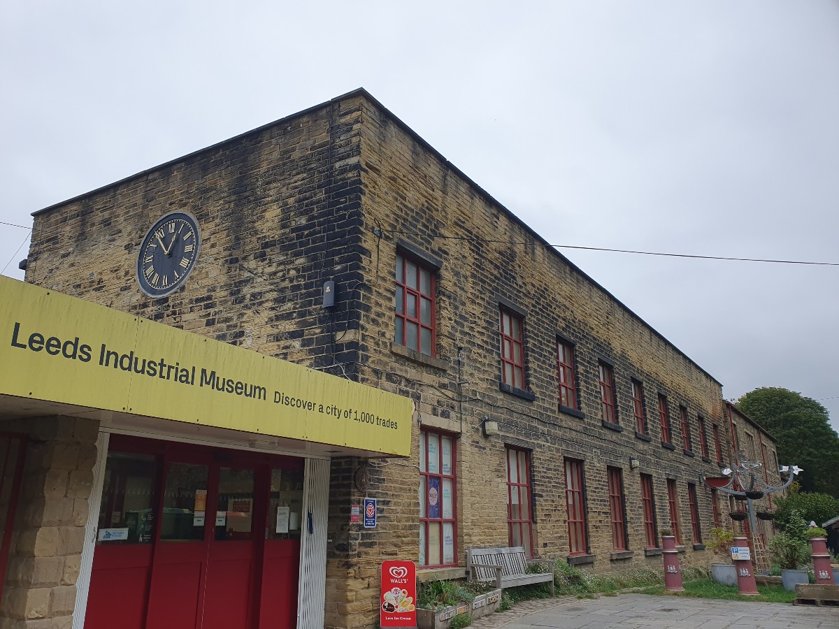 The image shows The Leeds Industrial Museum on a cloudy day in Armley