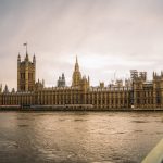 brown concrete building near body of water during daytime