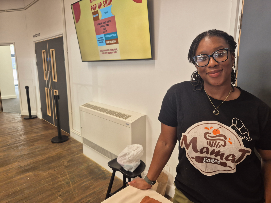 Andrea Tenebe: wearing a black shirt which says 'Mama T Bakes'