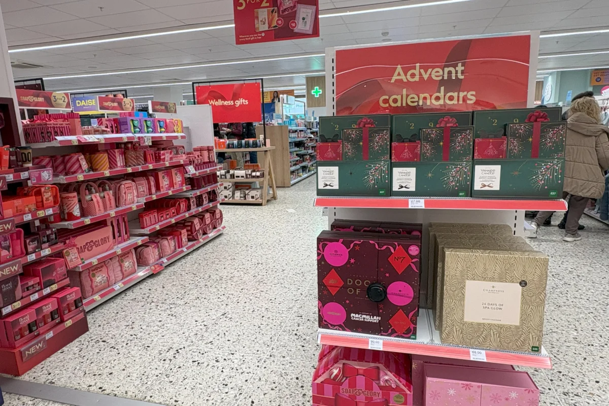 A display of Christmas gift sets and advent calendars on shelves.