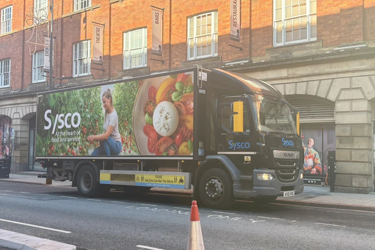 A delivery lorry parked on a city centre street. 