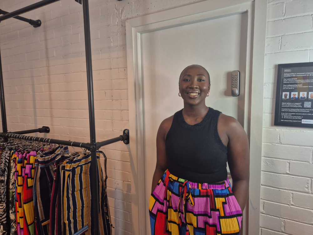 Ore Adeyemo. She wears a black tank top and vibrant pants