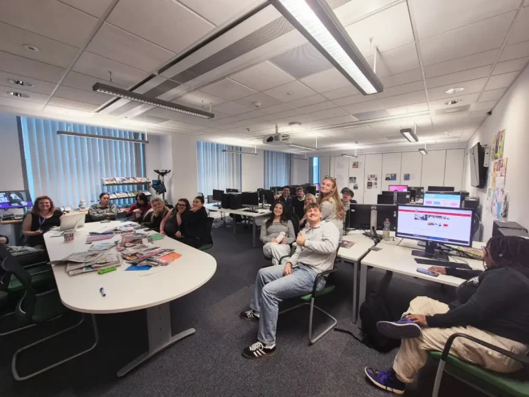 Group of people smiling in a IT room